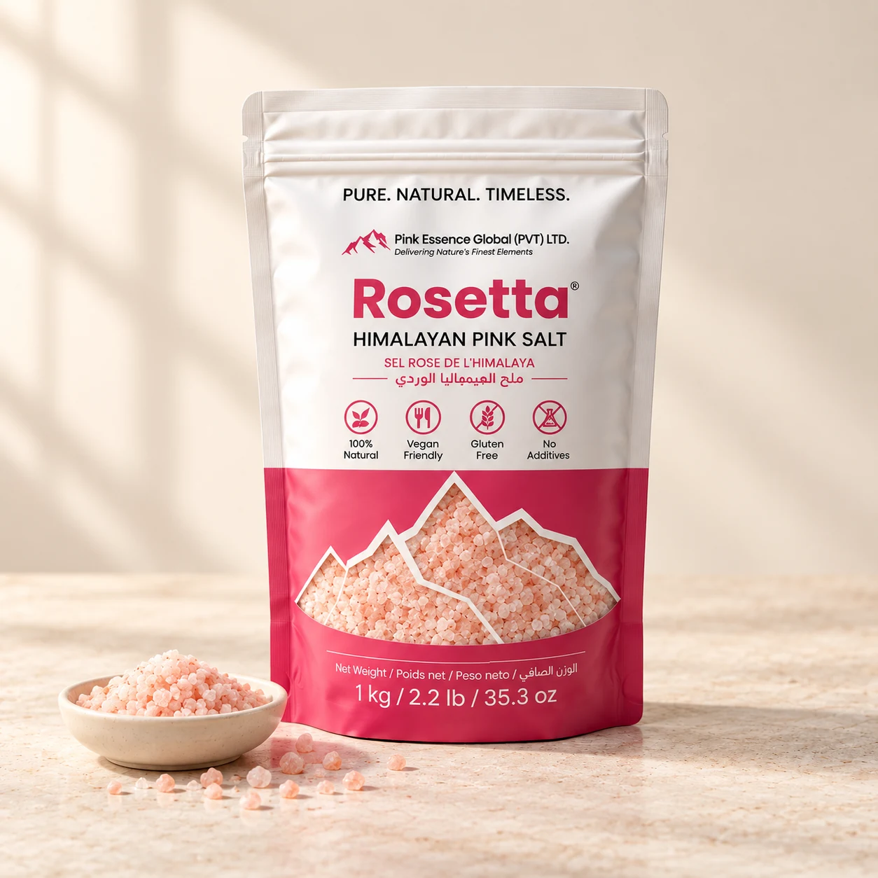 Rosetta pink salt pouch with visible salt crystals, a ceramic dish of pink salt in a warm ivory studio
